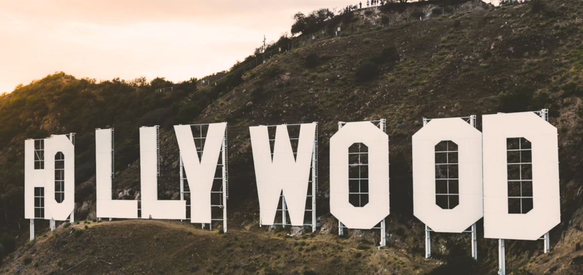 Hollywood sign on a hillside under a pale evening sky