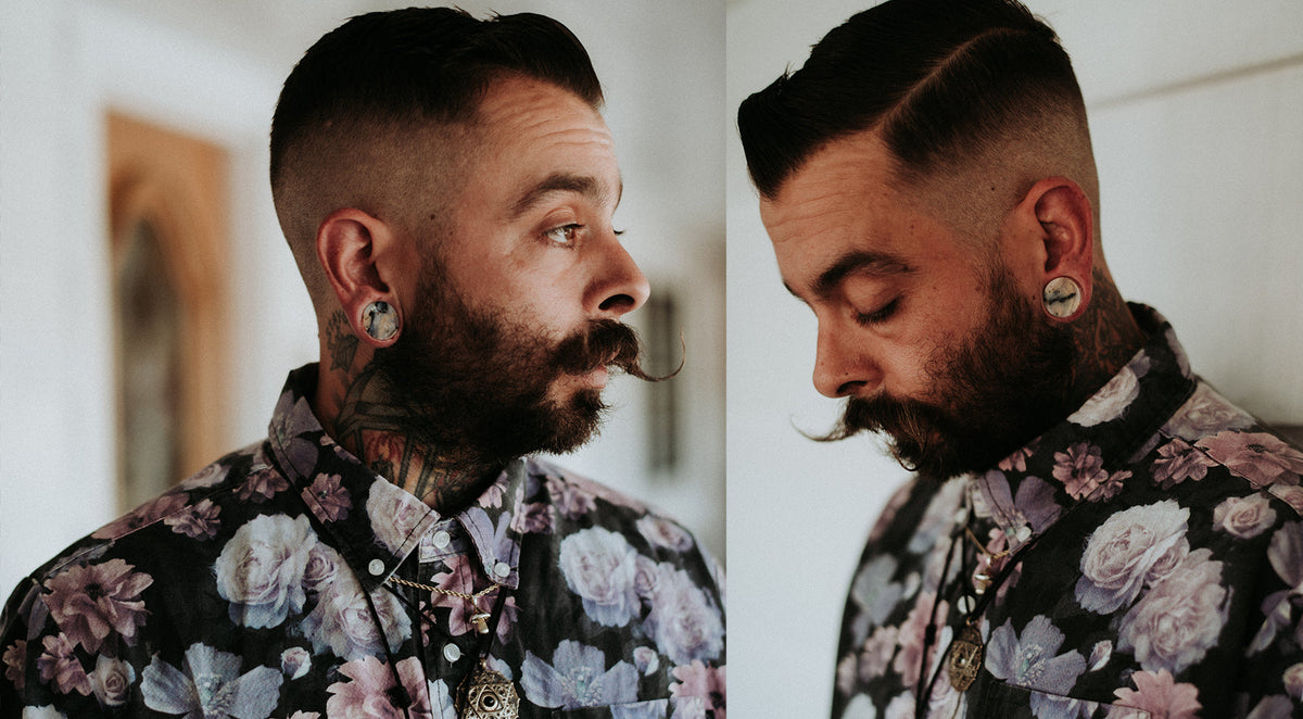 Two shots of a bearded man in a floral shirt, wearing small plugs in his stretched earlobes