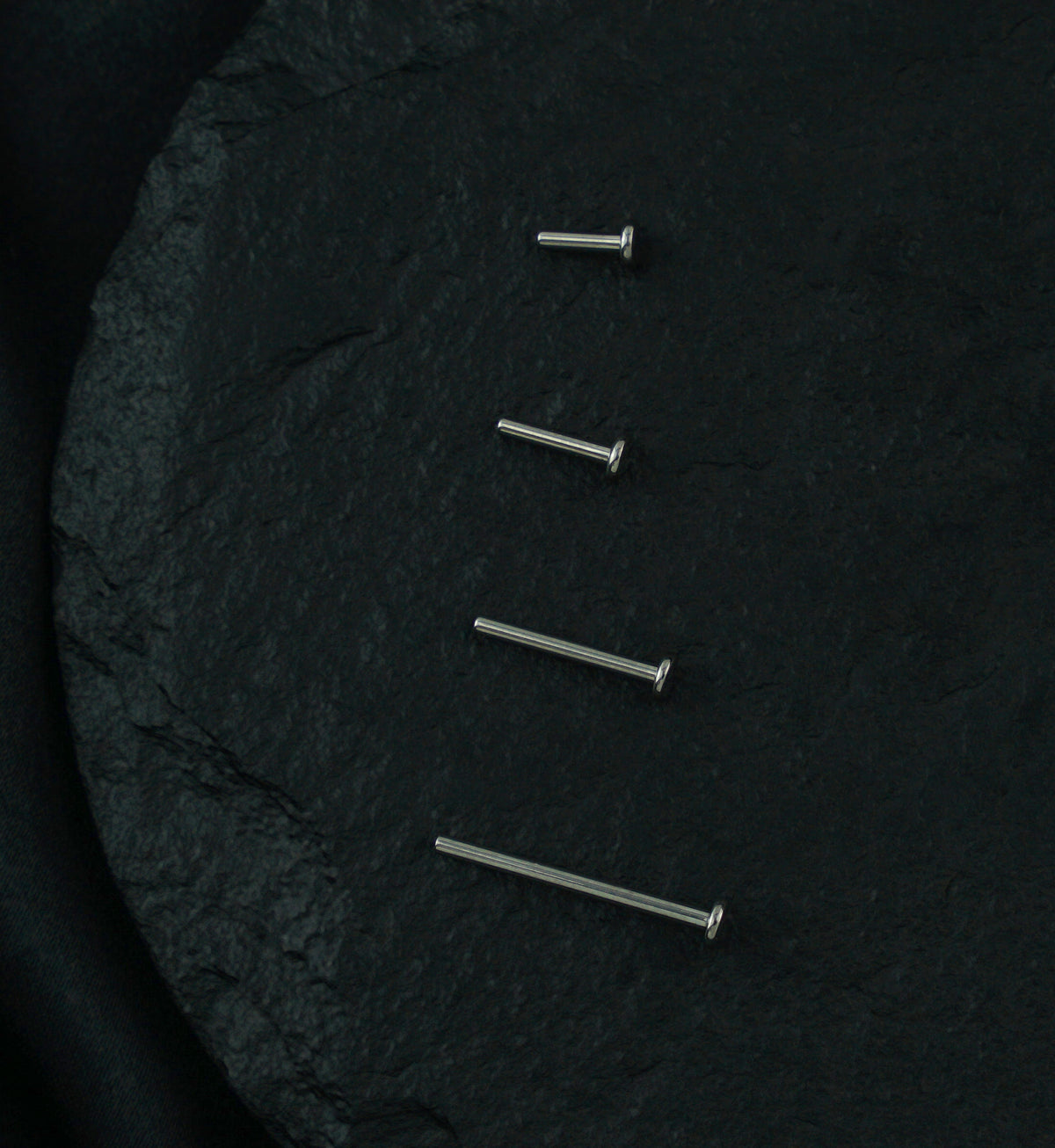 Titanium Threadless Labret, four posts in graduated lengths on dark stone