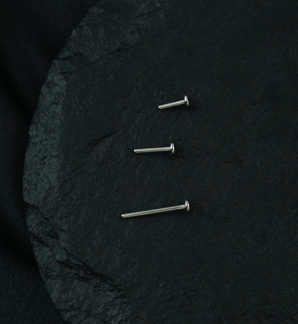 Titanium Threadless Labret, three post lengths on dark stone